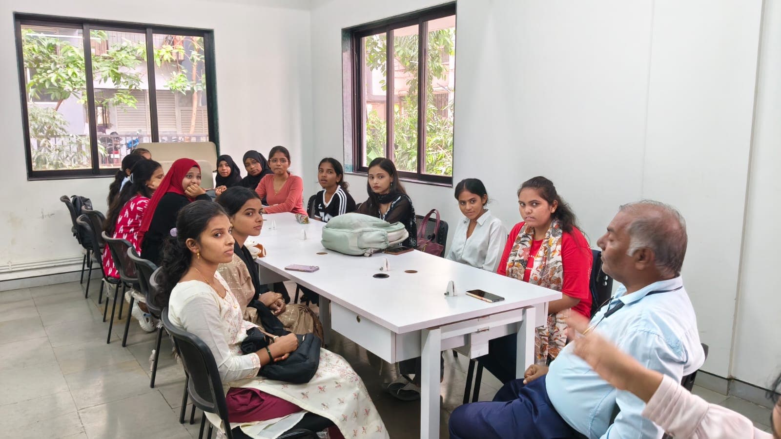 Students sit with a mentor around a table during a study session.